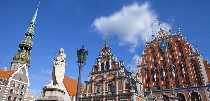 The historic House of the Blackheads, St. Peter's Church and statue of Saint Roland in the old town of Riga in Latvia.