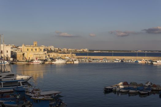 Sea bay between the Rivelino castle and the Church of Sain Mary of Canneto in the old town of Gallipoli (Le) in southern Italy