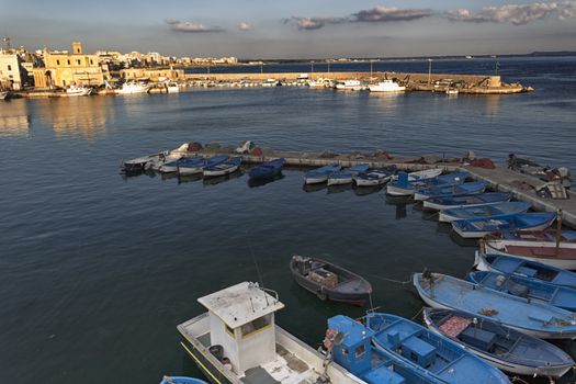 Sea bay between the Rivelino castle and the Church of Sain Mary of Canneto in the old town of Gallipoli (Le) in southern Italy