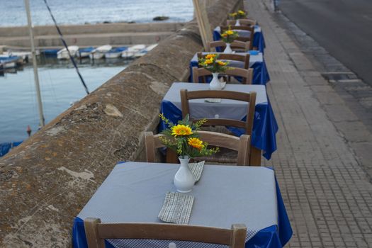 Restaurant on the sea bay between the Rivelino castle and the Church of Sain Mary of Canneto in the old town of Gallipoli (Le) in southern Italy