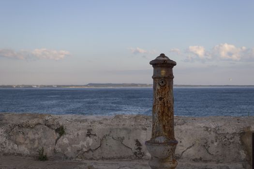 Old fountain  in front of the beach La Puritate in the old town of Gallipoli (Le)) in the southern of Italy