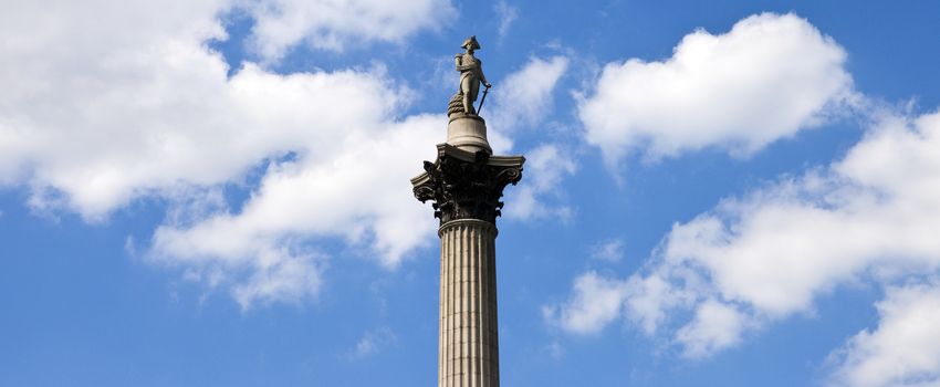 A panoramic view of Nelson's Column amongst the clouds in London.