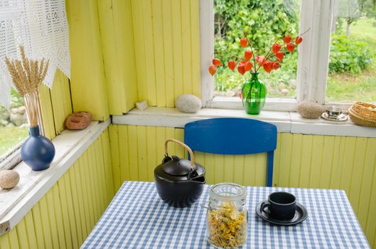 rural room harmony and black ceramic tea set with dried calendula on table