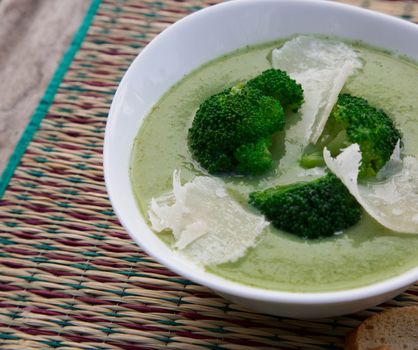 Broccoli cream soup with parmesan in the white plate