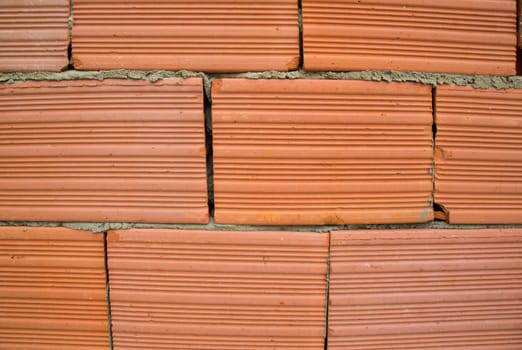 Red clay bricks attached by concrete. Background