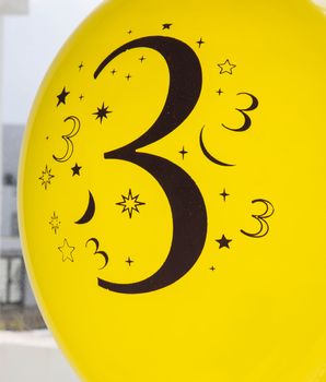 Number three is printed in black on the yellow balloon