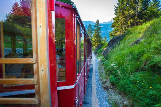 ST. WOLFGANG, AUSTRIA - AUGUST 6: Vintage train eith red carriages cogwheel railway going to Schafberg Peak (1783m) on August 6, 2013 in St. Wolfgang.