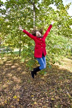 Photo of beautiful young woman with autumn leaves
