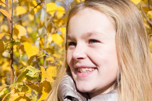 Photo of beautiful smiling girl in autumn