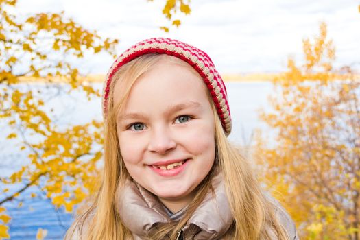 Photo of beautiful smiling girl in autumn