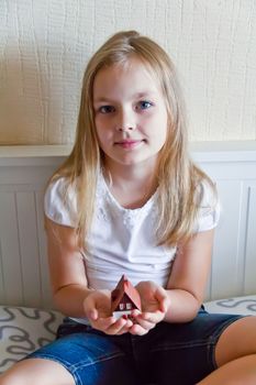 Cute girl with blond long hair and blue eyes