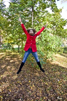 Photo of beautiful young woman with autumn leaves