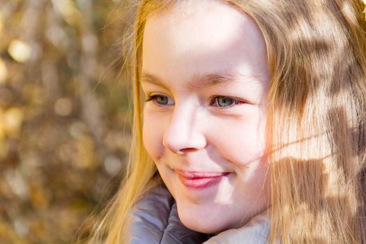 Photo of beautiful smiling girl in autumn