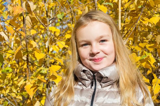 Photo of beautiful smiling girl in autumn