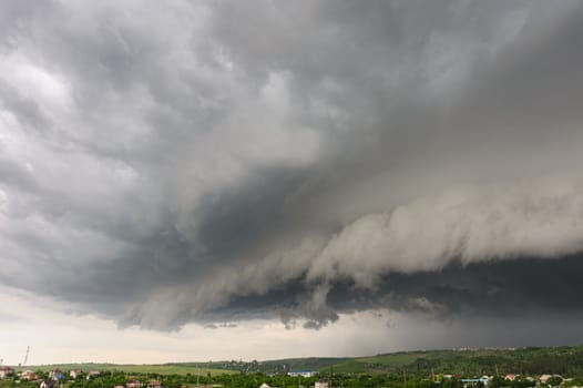 Beginning of the  storm with small tornado above the village