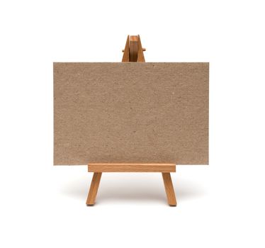 Small easel with sheet of paper isolated on white