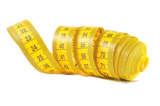 Roll of yellow measuring tape rolled up over white background