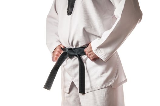 Man in martial arts uniform holding his black belt with both hands