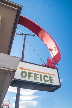 Motel office sign in city under bluesky