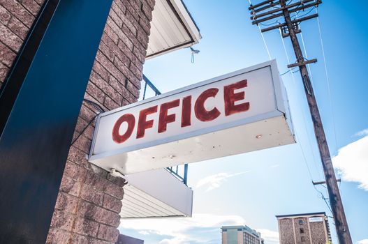 Motel office sign in city under bluesky