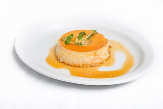 Delicious Brazilian Mexican caramel flan pastry dessert over white plate background