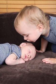 Toddler boy with his newborn baby brother