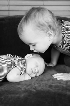 Toddler boy with his newborn baby brother