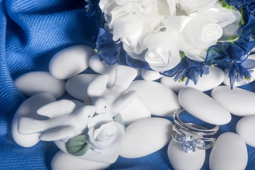  wedding rings on  a colorful fabric background