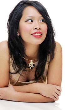 Asian lady looking away and smiling wears makeup