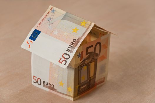 investment concept - house with money of 50 euros