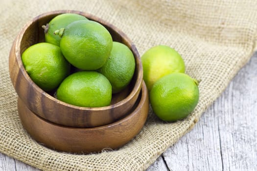 Wooden bowl filled with limes
