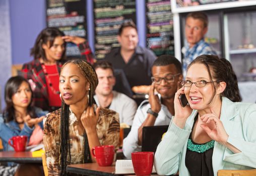 Annoyed students watching loud woman on cell phone