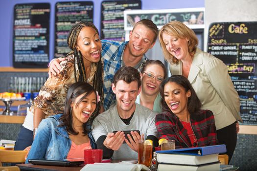 Smiling group of diverse students with camera phone