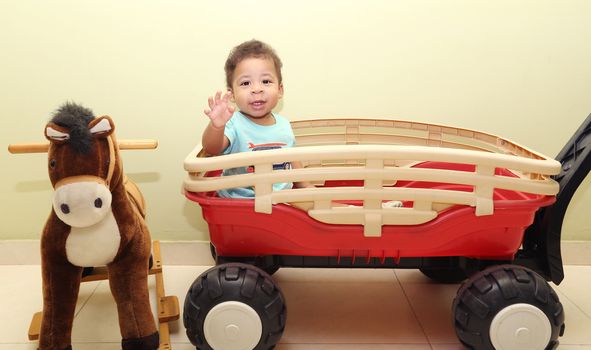 Portrait of a baby with toys looking at the camera