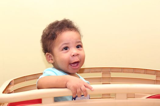 African baby sitting on his toy