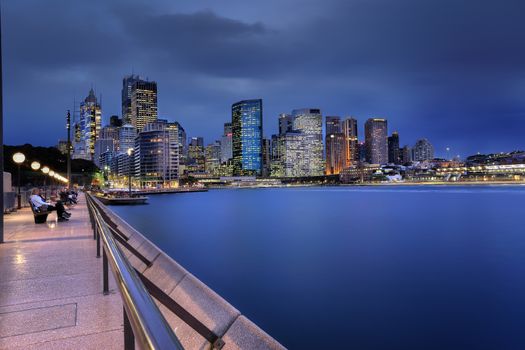 SYDNEY, AUSTRALIA - JULY 9, 2014; Circular Quay, Sydney at dusk as a storm blew in from the south west. Tourists relax on the foreshore.   Long Exposure  Australia