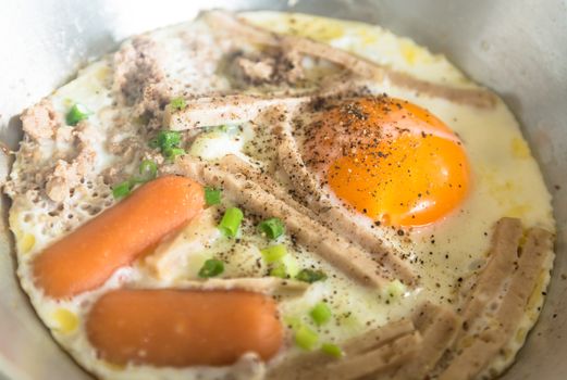 fried eggs with meat and vietnamese style sausage.