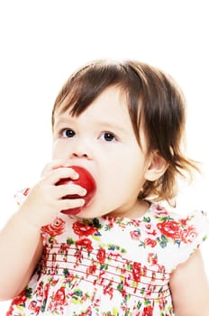 Young infant girl eating an apple