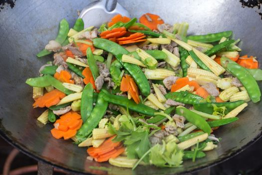 stir fried vegetables with pork in a pan