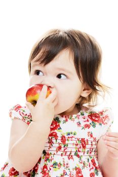 Cute little girl biting red apple closeup portrait