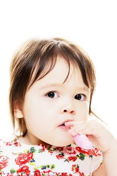 Closeup portrait of little girl brushing her teeth