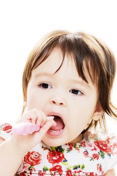 Young girl enjoys brushing her teeth closeup portrait