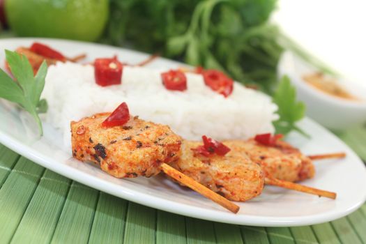 Asian sate skewers with rice on a light background