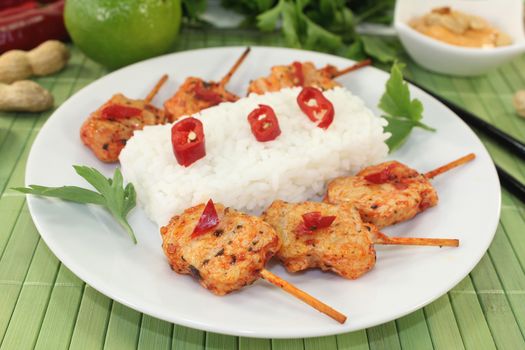 Asian sate skewers with rice and chili