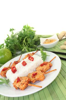 Asian sate skewers with rice and peanut sauce