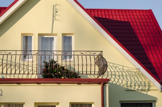 colorful country house and fallen Christmas tree on the balcony