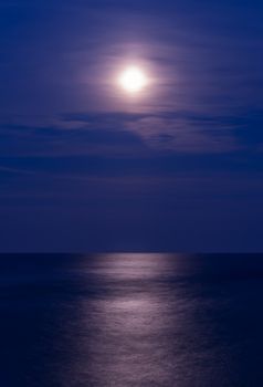 Full moon over the sea, vertical shot