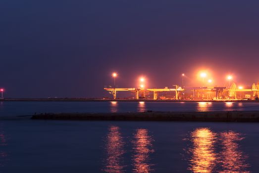 Industrial port at night under floodlights