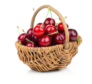 fresh cherries in a wicker basket isolated on white background
