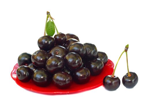 Ripe cherries in a small red platter